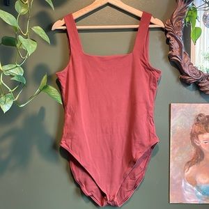 Burnt orange body suit